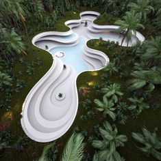 an aerial view of a pool in the middle of some trees and grass with water running through it