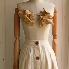 "This item is handmade in pure cotton fabric. Wonderful Italian fabric. Soft but firm hand. The skirt is made with small lateral folds both front and back. It has a short placket on the front, with a metal ciappa. Equipped with a 4 cm high corset, calculated for natural life. The placket with wooden buttons is fake. Finished internally, without lining. It is an elegant garment suitable for special occasions but also casual for use with flat shoes on a daily basis. Made of pure cotton fabric. Des Beige Cotton Skirt With Ruffles, Cotton Accordion Pleated Skirt Relaxed Fit, Cotton Accordion Pleated Skirt, Cotton Accordion Pleated Skirt In Relaxed Fit, Beige Pleated Cotton Skirt, Beige Cotton Pleated Skirt, Elegant Beige Cotton Maxi Skirt, Summer Cotton Skirt With Accordion Pleats, Beige Pleated Cotton Maxi Skirt