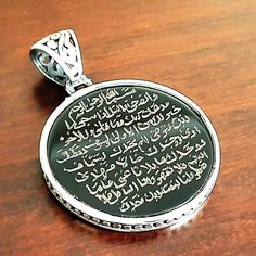 The verses of the Surah Duha from the Holy Quran were engraved by hand on the natural onyx stone, and the stone was framed in 925 sterling silver and turned into a necklace. The stone measures 30mm in diameter, while the pendant itself measures 32-33mm in diameter. It is handmade and crafted with 925 Sterling Silver from Turkey. Personalization or Custom Order: Stone color, stone shape, silver design, calligraphy. Attention Please: We try our best to provide a true representation of our products Traditional Onyx Jewelry As A Gift, Traditional Onyx Jewelry Gift, Engraved Onyx Jewelry As Gift, Engraved Onyx Jewelry For Gifts, Traditional Black Engraved Necklace, Black Pendant Jewelry For Blessing, Engraved Round Onyx Jewelry, Black Sterling Silver Jewelry With Engraving Option, Spiritual Necklaces With Engraving Option For Commemoration