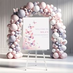 a welcome sign surrounded by balloons and butterflies