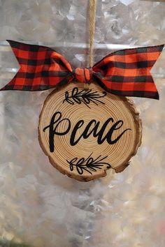 a wooden ornament with the word peace on it