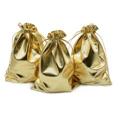 three gold metallic bags sitting next to each other