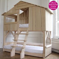 a wooden bunk bed with a ladder to the top that is attached to it, in front of a window