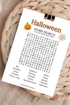 a halloween word search on a clipboard in a wicker basket with the words written below it