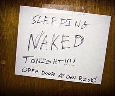 a sign posted on a door that says sleeping naked tonight open door at own risk