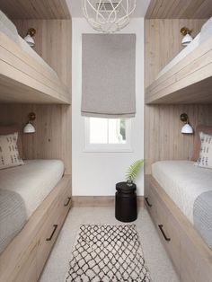 a bedroom with three bunk beds and a rug on the floor