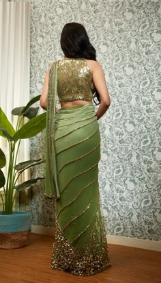 Perfect Times embodies its name, crafted from a delicate georgette base, the pre-stitched saree features net pleats, sequins, and golden beaded embroidery, which are intricately done to create a stunning texture. The saree comes with a matching halter blouse in the same shade and features delicate embroidery work, which perfectly complements the design of the saree.From Papa Don’t Preach’s Capsule collection. DELIVERY TIMEPlease allow 8-12 weeks for your outfit to arrive. FABRIC DETAILSGeorgette Embellished Saree, Green Sari, Halter Blouse, Party Attire, Tulle Sleeves, Saree Designs Party Wear, Delicate Embroidery, Korean Street, Stylish Sarees