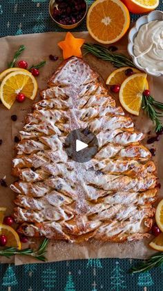 an orange cake with icing and fruit on the side, surrounded by other ingredients