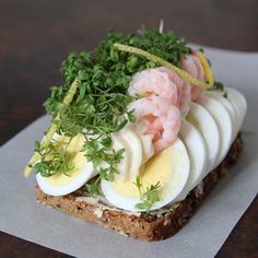 a sandwich with hard boiled eggs, shrimp and parsley