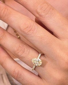 a woman's hand with a diamond ring on it