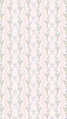 a pink and blue wallpaper with small flowers on the bottom half of it,