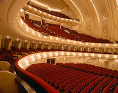 an empty auditorium filled with red seats