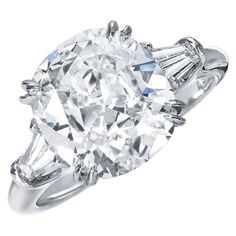 an oval cut diamond ring with baguetts on the shoulders