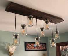 mason jar chandelier hanging from the ceiling in a bathroom with deer head on the wall