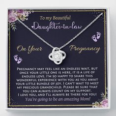 a necklace with a poem written on it in front of a purple flowered background