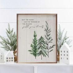 a white shelf topped with christmas decorations and a wooden sign