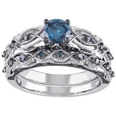 a blue diamond ring set on top of a white gold band with black and gray diamonds