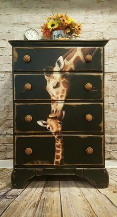 a giraffe painted on an old dresser