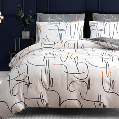 a bed with an orange and black pattern on it