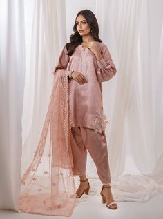 Make a stunning impression in this statement piece The short shirt, adorned with delicate cut work along the hemline, The neckline is embellished with intricate detailing, enhancing the neckline and framing with grace and poise. Paired gracefully with a straight shalwar in the same serene hue and matching organza dupatta, adorned with intricate embroidery and delicate finishing touch. Shirt: Self JacquardPants: Self JacquardDupatta: Organza Wedding Tops With Dupatta For Eid, Wedding Chikankari Embroidery Top For Eid, Wedding Tops With Chikankari Embroidery For Eid, Eid Wedding Tops With Chikankari Embroidery, Fitted Cutwork Sets, Eid Organza Blouse With Intricate Embroidery, Organza Blouse With Chikankari Embroidery, Summer Wedding Blouse With Chikankari Embroidery, Summer Wedding Blouse With Intricate Embroidery