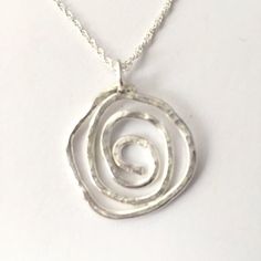 A beautiful handmade and hammered Celtic style sterling silver spiral everyday pendant with a lovely polished finish. The 3 cm wide pendant hangs from a sterling silver bail and an 18'' / 45 cm sterling silver chain which fastens with a bolt clasp. Other chain lengths are available - please see below. This lovely minimalist pendant is perfect for any occasion and would make a lovely gift for a birthday, bridesmaid or valentines day.  I created the pendant with sterling silver wire and added the Everyday Pendant, Wave Jewelry, Gifts For Friend, Spiral Pendant, Minimalist Pendant, Celtic Style, Hammered Sterling Silver, For Her Gifts, Birthday Gift For Her