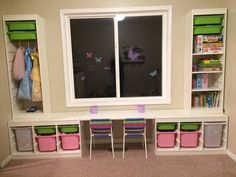 a playroom with toys, bookshelves and storage bins