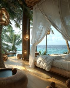 a bed sitting on top of a wooden floor next to palm trees and the ocean