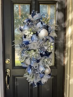 a blue and white wreath on the front door