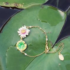 Instill your look with an exquisite touch of nature with our Lotus Dragonfly Bracelet. Crafted from brass enamel, this stunning piece is suitable for either festive occasions or everyday wear, making it an ideal gift. Its subtle yet impactful beauty will bring graceful elegance to any ensemble. DETAILS Plating: 18K Gold Materials:   18K Gold on Brass, Enamel Measurements:  Length: 6.10"(15.5cm) + Extender: 2.36"(6.0cm) Weight:  6.2g Charming Bracelet, Lotus Bracelet, Dragonfly Gifts, Dragonfly Bracelet, Lotus Jewelry, Unique Gift Wrapping, Dragonfly Jewelry, Detailed Necklace, Hand Necklace