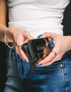 a woman holding an old camera in her pocket