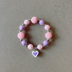 Pink bracelet for girl kid beaded bracelet for kids purple heart bracelet pink beads necklace for children heart charm bracelet gift for kid This delightfully cute Kids bracelet is perfect for your little one! Constructed with an elastic cord, it is both easy and safe for your child to put on and take off. The colorful pink and purple beads, paired with the heart charm, make this bracelet the perfect accessory for your kid. Item Details *Material: Acrylic, Rice beads, Silicone *Bracelet size: 5i Purple Round Beaded Jewelry For Mother's Day, Cute Heart Beads Beaded Bracelets For Valentine's Day, Cute Heart Beaded Bracelets For Valentine's Day, Purple Adjustable Heart Bracelet For Valentine's Day, Adjustable Purple Heart Bracelet For Valentine's Day, Adjustable Purple Charm Bracelet For Birthday, Purple Beaded Charm Bracelet For Friendship, Cute Beaded Bracelets With Heart Charm, Playful Heart Beads Jewelry For Birthday