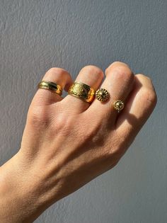 Elevate your style with our exquisite collection of gold stacking rings, exclusively available at Christina Christi Store. Crafted to perfection, this set features a medium-width ring with engraved edges, a mesmerizing evil eye design on the middle ring, and a uniquely stunning ring with two spheres at the edges. Each ring is slightly adjustable for a comfortable fit on any finger. With a diameter of 17mm (0.67'') or US size 7, these rings are versatile for any occasion. Please note that each ri Gold Recycled Open Band Ring, Gold Rings With Recycled Gold Open Band, Gold Open Band Rings In Recycled Gold, Gold Stackable Wide Band Rings For Everyday, Gold Open Ring In Recycled Material, Gold Wide Band Stackable Rings For Everyday, Gold Open Ring In Recycled Gold, Gold Open Ring With Recycled Gold, Adjustable Gold Wide Band Ring For Everyday