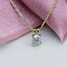 Elegant 1.00 carat round moissanite pendant in a 14k solid gold 4-prong basket setting. A timeless necklace, perfect for everyday wear or as a thoughtful anniversary gift. ✥𝐒𝐭𝐨𝐧𝐞 𝐃𝐞𝐭𝐚𝐢𝐥𝐬 → Shape: Round  → Stone Type: Moissanite Diamonds → Weight: 1.00 Carat → Color: D (Colorless) → Clarity: VVS → Polish: Excellent → Symmetry: Excellent → Luster: Excellent → Make: High Quality 𝐍𝐨𝐭𝐞: The chain is not included; we can provide it for you upon request. Please note that there will be a Anniversary Necklace With Lab Grown Diamond And Prong Setting, Anniversary Necklace With Lab Grown Diamond In Prong Setting, Gold Solitaire Diamond Necklace Gift, Gift Solitaire Necklace In Yellow Gold With Diamond Accents, Yellow Gold Solitaire Necklace With Diamond Accents As Gift, Anniversary Diamond Solitaire Necklace, Gift Diamond Necklace In Diamond White With Round Cut, Formal 14k Gold Solitaire Necklace With Round Cut, Round Moissanite Necklace With Prong Setting