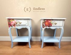 two blue nightstands with flowers painted on the top and bottom, sitting side by side