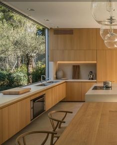 a modern kitchen with wooden cabinets and counter tops