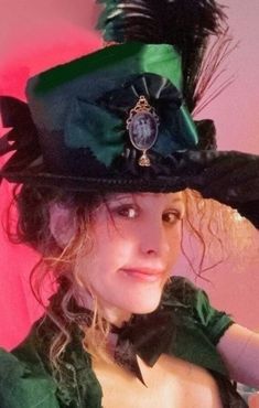 "Victorian/ Belle Epoque/ Steampunk  (or possibly Late Jacobean with the right attire) Ladies Top Hat in sumptuous Hunter Green satin with high quality black gimp trim. Featured in the front is a knife pleated satin ribbon rosette centered by the buyer's choice of antique style Cameo Brooch depicting the Three Graces or Conch Maiden, both with Mughal Style Crystal Dangles* (all the rage during The Empire Period.)Decorating the side of this hat are peacock and goose feathers, topped with a large Steampunk Hats Women, Steampunk Belle, 3 Graces, Top Hat Costume, Edwardian Hat, Steampunk Top, Steampunk Top Hat, Grey Sapphire, Victorian Hats