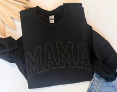 Be the coolest mama on the block in our black on black mama sweatshirt. Perfect for running around doing all your mom duties! **CUSTOM DESIGN ** we will gladly custom design picture color name or Quote just show us what you need by contacting us only through ETSY message us ( MESSAGE SELLER) , we will get back to you within few hours if not same hour."" ** NEED HELP TO ORDER ? (Please keep reading for all details about the product and Care instructions) ** * Select your item's Size and the size Black On Black Sweatshirt, Mama Crewneck Sweatshirt, Womens Sweatshirts, Puff Print, Mama Sweatshirt, Black On Black, Gildan Sweatshirts, Mom Sweatshirt, Heather White