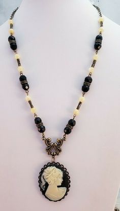 This is a wonderful Vintage Reproduction Faux Cameo Woman Silhouette Pendant Mixed Beaded Necklace. The metal is a dark brass tone. The necklace measures 20" long and an be made shorter and weighs 1oz. It has Never been worn, Made of some vintage pieces. Items are shipped from a smoke-free home. Photos are part of the listing so PLEASE look at all pictures. And if an item is Sterling Silver it may tarnish in time, I suggest you buy a Polishing Cloth (one brand is called SUNSHINE CLOTH) and take care of it, Wearing it in water will also cause tarnishing. I will combine shipping. Use the shopping cart it will make it easier to do so. Items must be returned in the condition they were received. Will only return if there is something wrong with them. Shipping cost includes price for packing mat Is Something Wrong, Antique Jewelry Necklace, Woman Silhouette, How To Make Shorts, Vintage Pieces, In Water, Vintage Watches, Shopping Cart, Antique Jewelry