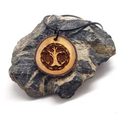 This wooden pendant is engraved with our original Celtic tree of life design. In Celtic culture, the tree of life is believed to be a symbol of wisdom, harmony and the interwoven nature of existence. In Celtic legends, trees guard sacred wells, and Druids were known to hold their sacred rites in groves of oak trees. *This wooden pendant is created with locally sourced wood and treated with mineral oil to preserve and hydrate the wood. *Comes with a 20-inch waxed cord with a 2-inch chain extender Wooden Pendant Necklace, Sacred Well, Celtic Legends, Tree Of Life Design, Celtic Culture, Celtic Tree Of Life, Celtic Tree, Oak Trees, Scottish Wedding