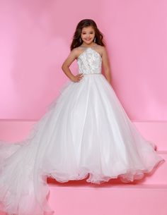 Sugar Kayne C143 Girls and Preteens Pageant Dress. This is a beautiful flowy organza pageant gown with embellished high neckline. This dress features an organza ruffle that flows down the back of the dress. Colors: Royal, Yellow, Hot Pink, White Sizes: 2-16 (Sizes 2-6 do not have bust cups, Sizes 8-16 will have preteen size bust cups) Fabric: Satin, Organza, Stretch Lace Pageant Dresses For Teens, Royal Yellow, Pageant Gown, Dress Colors, Organza Skirt, Bridal Ball Gown, Girls Pageant Dresses, Patriotic Outfit, Unique Prom Dresses