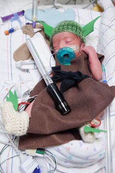 a baby in a crib with an oxygen tube attached to it's head