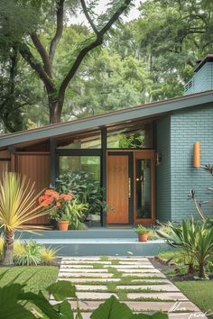 a small blue house surrounded by trees and plants