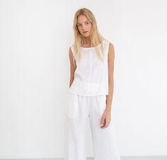 "RILEY is a wide leg cropped linen culottes. DETAILS - Cropped length - Seam pockets - Wide leg - Elasticated waist - 100% lightweight European linen fabric - Cut and sewn to order just for you in our studio COLOR - White (slightly see through), you can also choose other colors above - Fabric samples are available here https://www.etsy.com/listing/586569696/linen-fabric-samples SIZING & FIT - Fits true to size - Length is approximately 35.5 inches / 90 cm - Waist is approximately 13 inches / Summer Linen Wide-leg Capris, Loose Fit Linen Wide-leg Culottes, Ankle-length Linen Culottes With Pockets, White Linen Wide-leg Harem Pants, White Linen Full-length Bottoms, Linen Culottes, Linen Sleeveless Top, White Linen Trousers, Linen Dress Summer