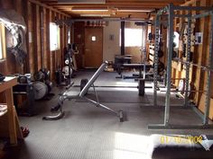 the inside of a home gym with equipment