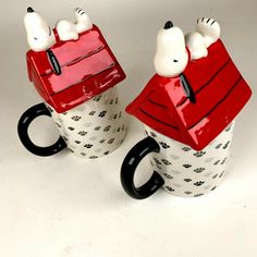 two coffee mugs with dogs on them sitting side by side in front of each other