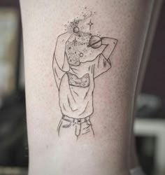 a woman's leg with a tattoo on it that has an image of a person holding