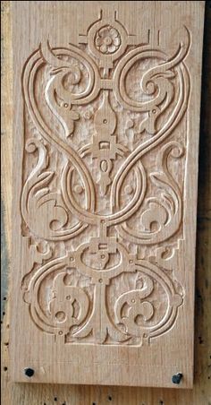 a wooden block with an intricate design on it