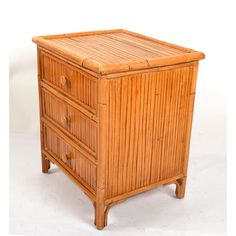 an old bamboo dresser with drawers on it