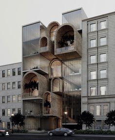 a car driving past a tall building on the side of a road with lots of windows and balconies