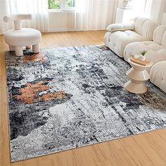 a living room with white couches and an area rug